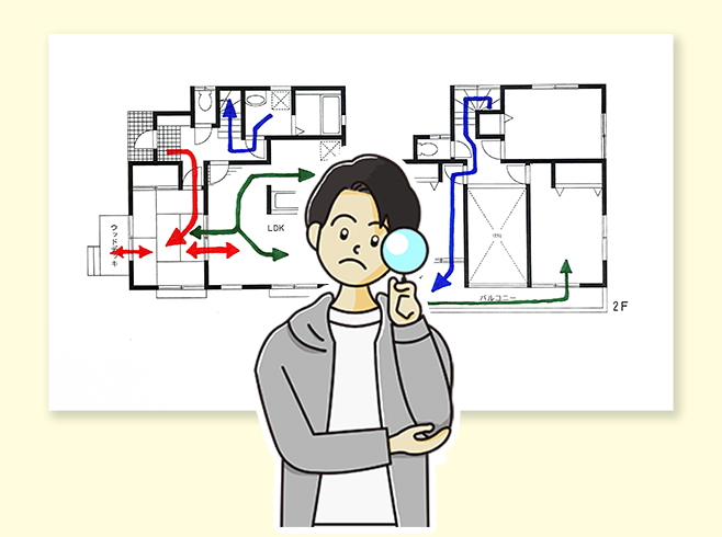 間取り図から家具の配置や生活導線を考える男性